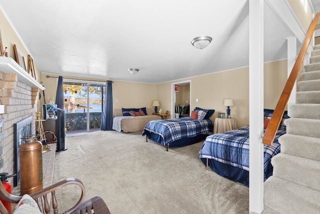 bedroom featuring a fireplace and carpet flooring