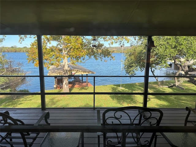 unfurnished sunroom featuring a water view