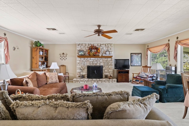 carpeted living room with ceiling fan, a fireplace, and ornamental molding