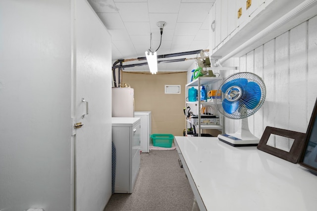 washroom featuring carpet, water heater, and washer and clothes dryer