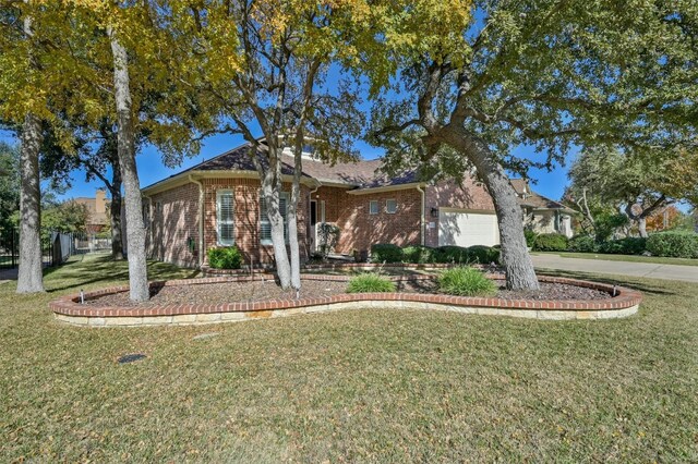 ranch-style home with a garage and a front yard