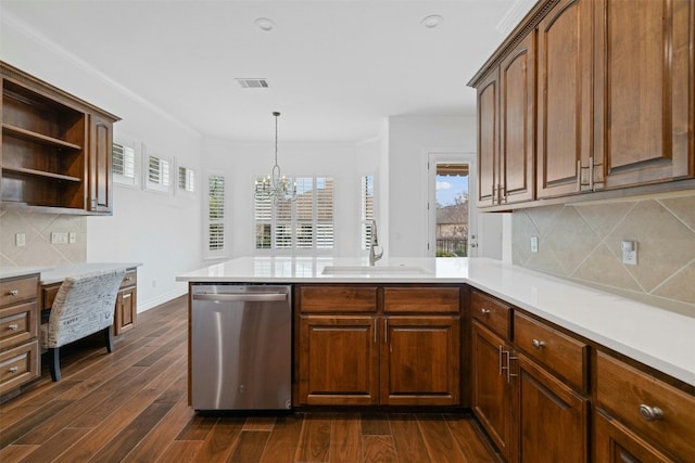 kitchen with stainless steel dishwasher, tasteful backsplash, hanging light fixtures, sink, and dark hardwood / wood-style floors