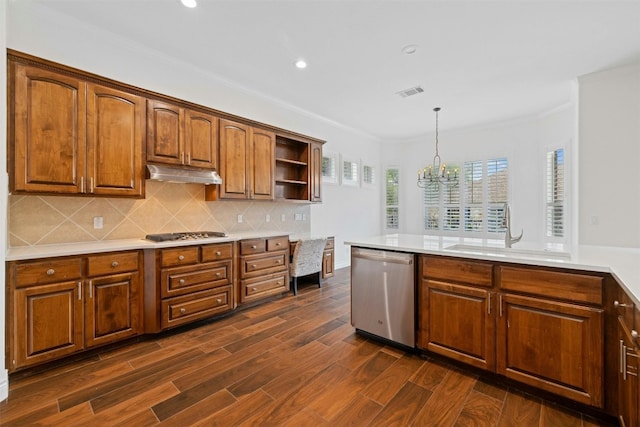 kitchen featuring dishwasher, dark hardwood / wood-style floors, decorative backsplash, pendant lighting, and sink