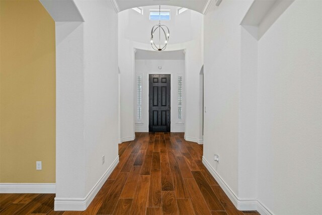 hallway featuring a notable chandelier and dark hardwood / wood-style floors