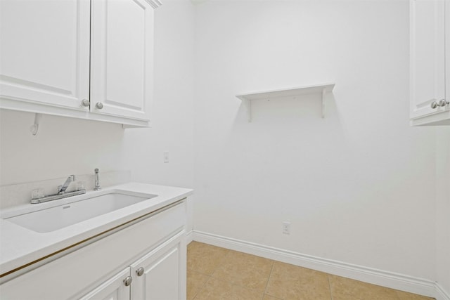 laundry area with sink and light tile patterned floors