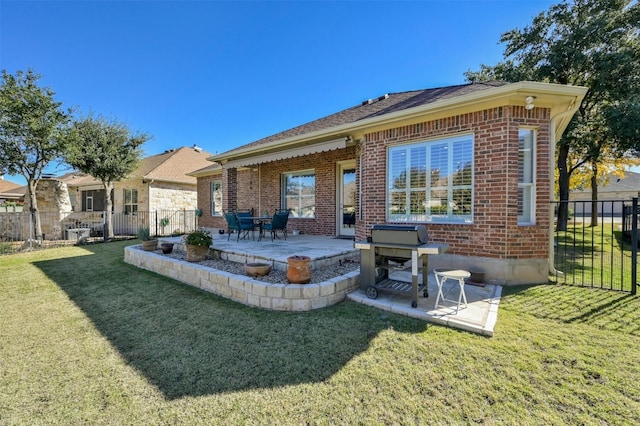 rear view of property with a patio area and a yard