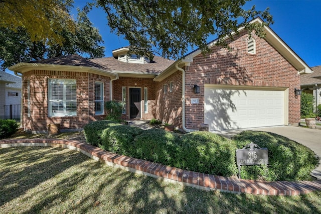 view of front of property with a garage and a front yard