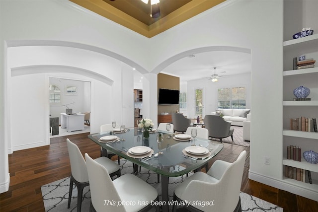 dining area featuring built in features, dark hardwood / wood-style flooring, and ceiling fan