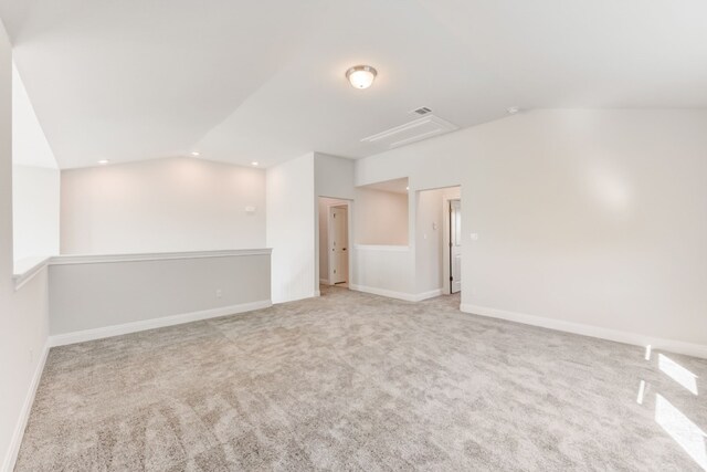 carpeted empty room featuring recessed lighting, visible vents, vaulted ceiling, and baseboards