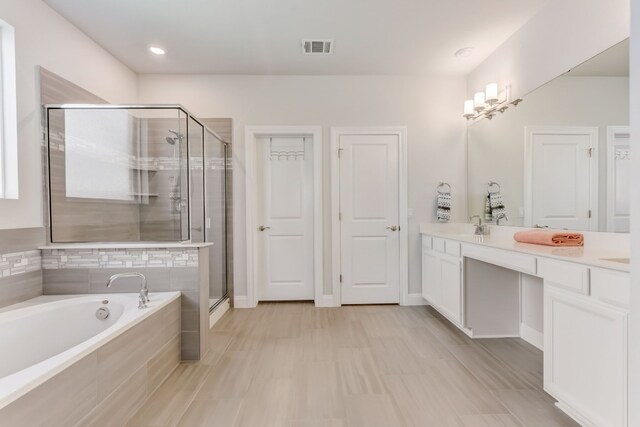 full bathroom with double vanity, a garden tub, visible vents, and a shower stall