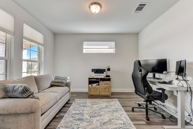 office with wood finished floors, visible vents, and baseboards