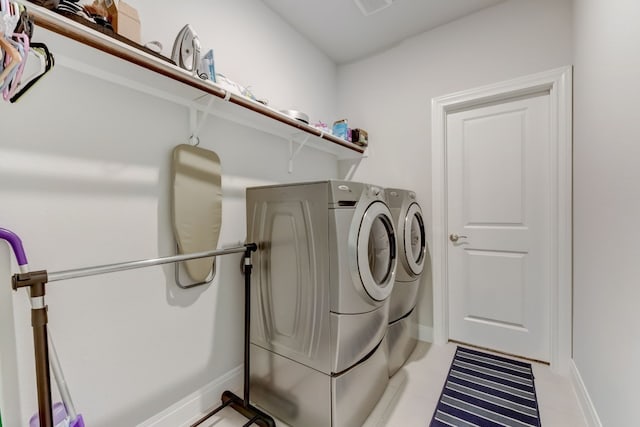 washroom featuring laundry area, independent washer and dryer, and baseboards