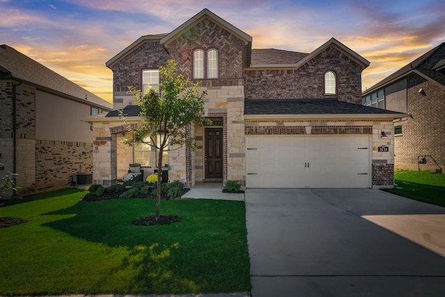 view of front of home featuring a garage, concrete driveway, a front lawn, and brick siding
