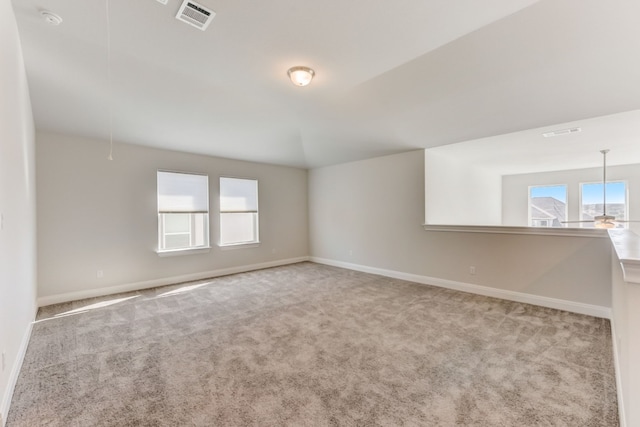 spare room with a healthy amount of sunlight, visible vents, and baseboards