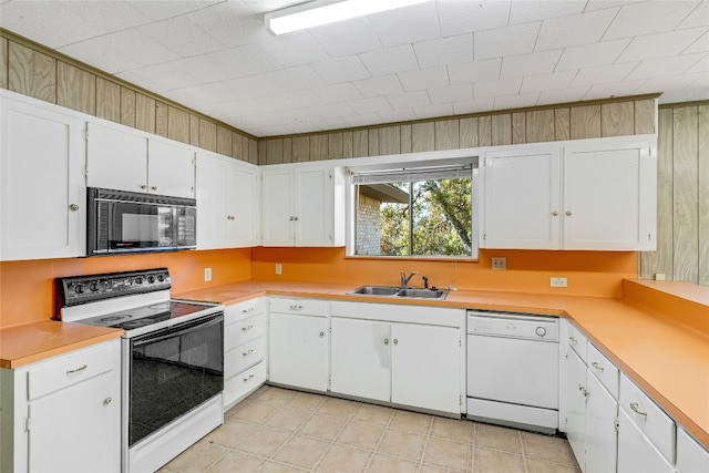 kitchen with sink, white cabinets, and white appliances