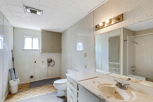 full bathroom with tiled shower / bath, vanity, and toilet