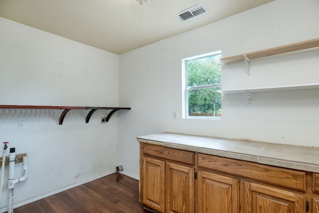 interior space featuring tile counters and dark hardwood / wood-style floors