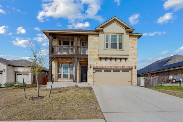 view of front of house with a garage, solar panels, a front lawn, and a balcony