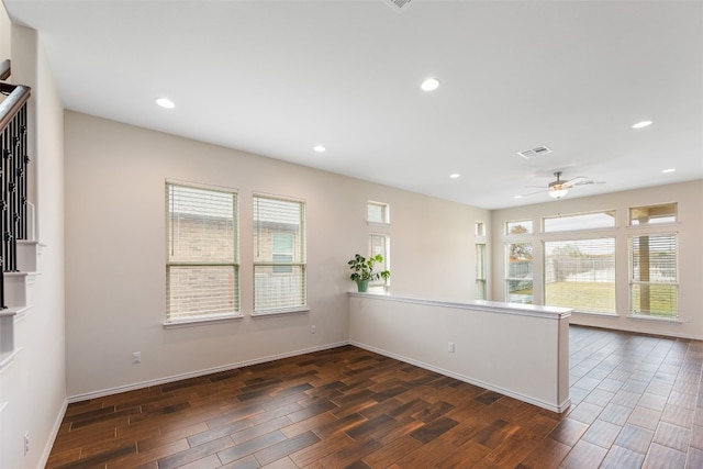 empty room with ceiling fan and dark hardwood / wood-style flooring