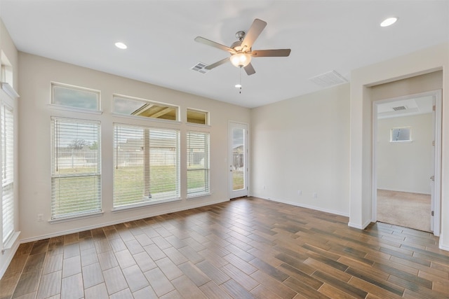 carpeted empty room featuring ceiling fan