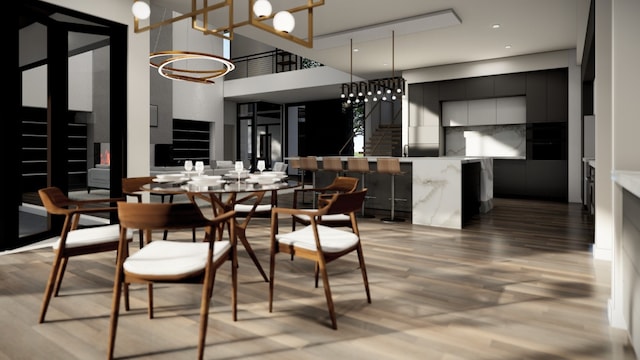 dining space with a high ceiling, stairs, and light wood-style floors