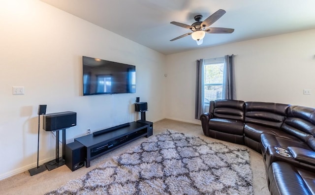 carpeted living room featuring baseboards and ceiling fan