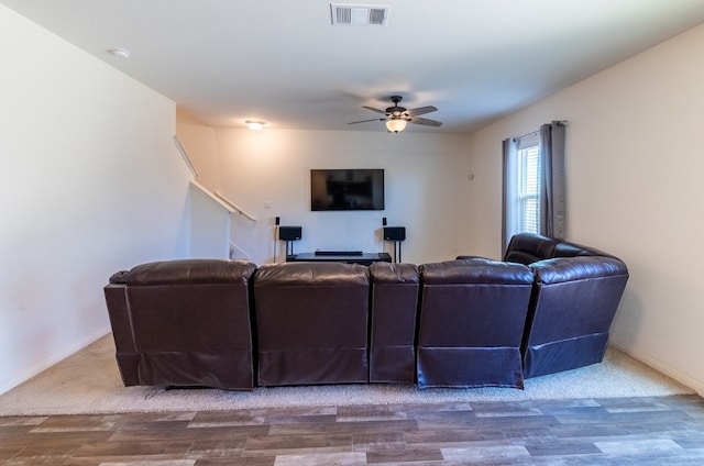 living room featuring hardwood / wood-style floors and ceiling fan