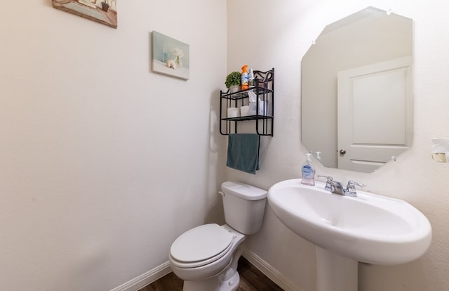 bathroom featuring hardwood / wood-style floors, toilet, and sink