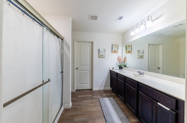 bathroom with a shower with curtain, wood-type flooring, and vanity