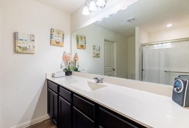 bathroom featuring vanity, hardwood / wood-style flooring, and curtained shower