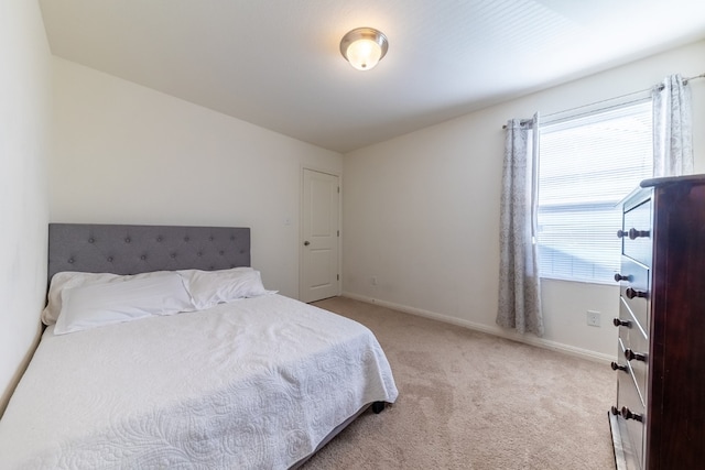 bedroom featuring light colored carpet