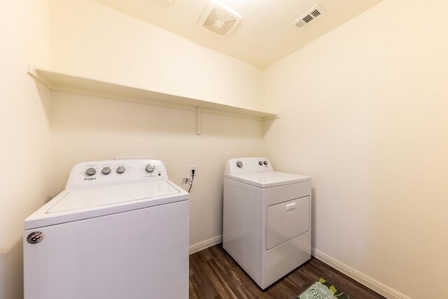 laundry area with washer and clothes dryer and dark hardwood / wood-style floors