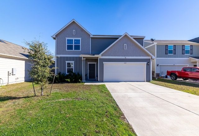 view of front of home with a front lawn and a garage