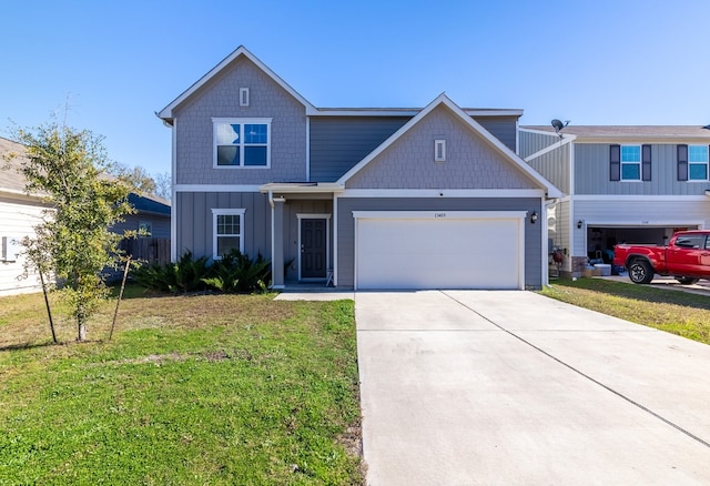 view of front of property featuring a garage and a front lawn