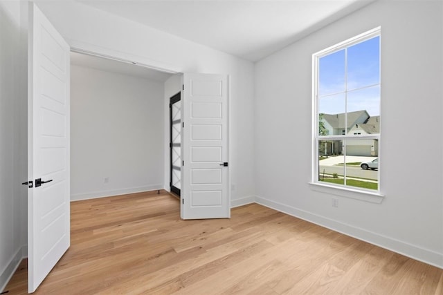 unfurnished bedroom featuring light wood-type flooring