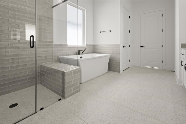 bathroom featuring vanity, shower with separate bathtub, and tile walls