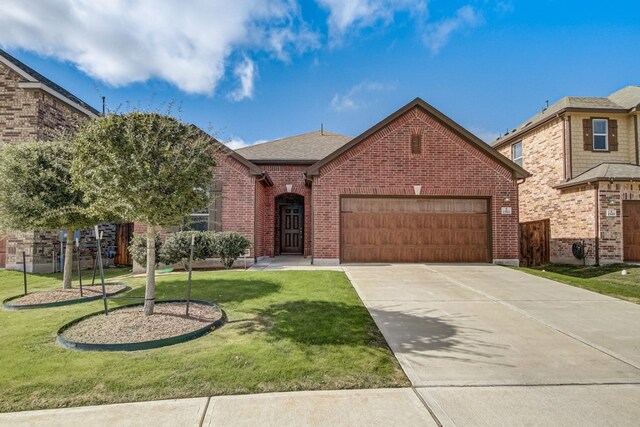 view of front of home featuring a garage and a front lawn