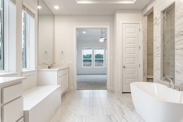 full bathroom featuring baseboards, a soaking tub, marble finish floor, vanity, and recessed lighting