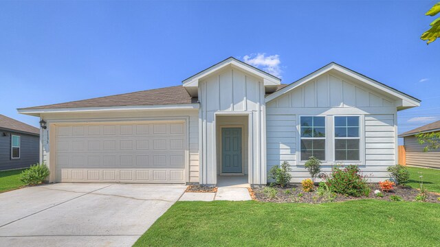 view of front of house featuring a garage and a front lawn