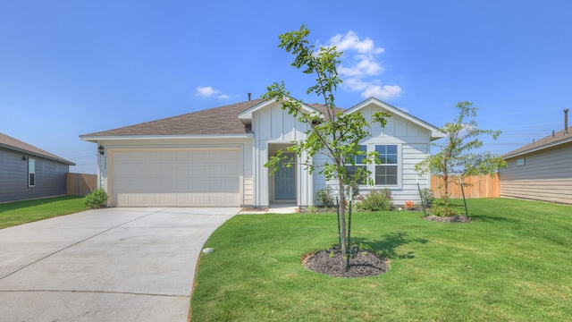 view of front of property with a garage and a front lawn