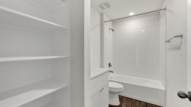 full bathroom with hardwood / wood-style flooring, toilet, vanity, and tiled shower / bath