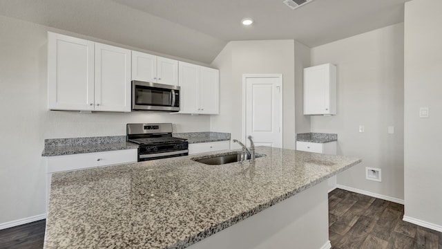 kitchen with sink, appliances with stainless steel finishes, white cabinets, and light stone countertops