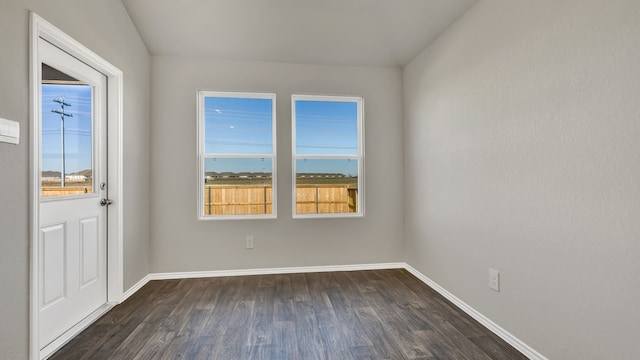 spare room with dark hardwood / wood-style flooring