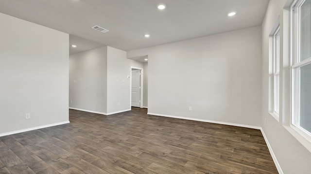 spare room with dark hardwood / wood-style floors