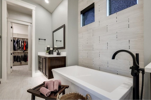 bathroom with vanity and a bath