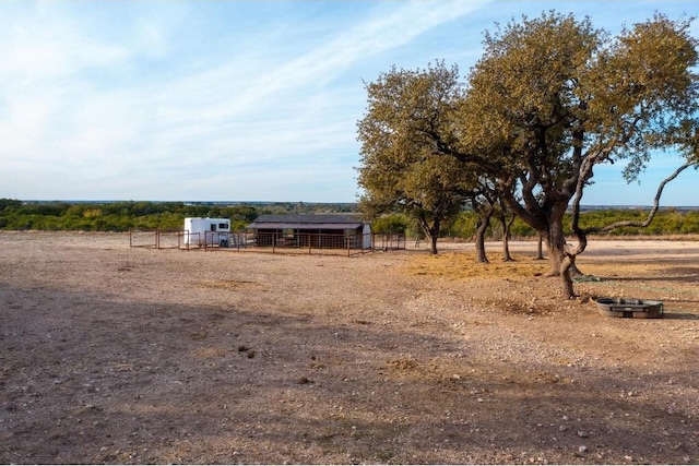 view of yard featuring a rural view and an outdoor structure