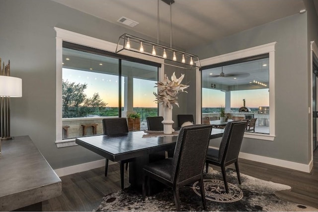 dining space with ceiling fan, plenty of natural light, and dark hardwood / wood-style floors