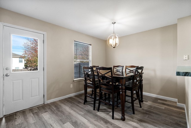 dining space featuring an inviting chandelier and dark hardwood / wood-style floors