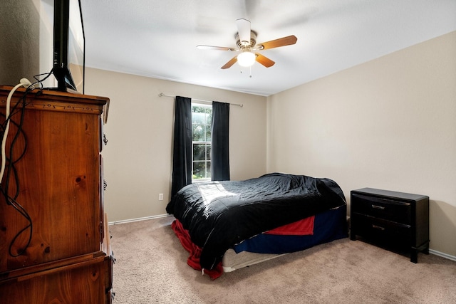 bedroom with ceiling fan and light carpet