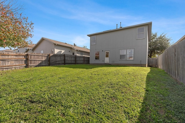 rear view of property with a lawn